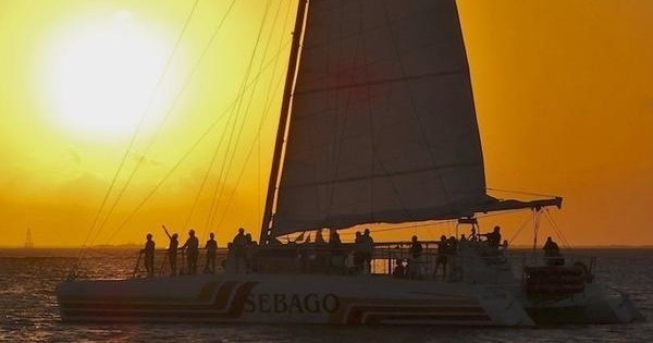 a 69' sail Catamaran and its passengers watch the amazing Key West sunset.