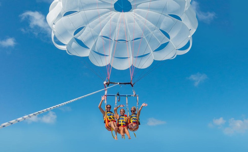 a group of people Parasail across the waters of Key West.