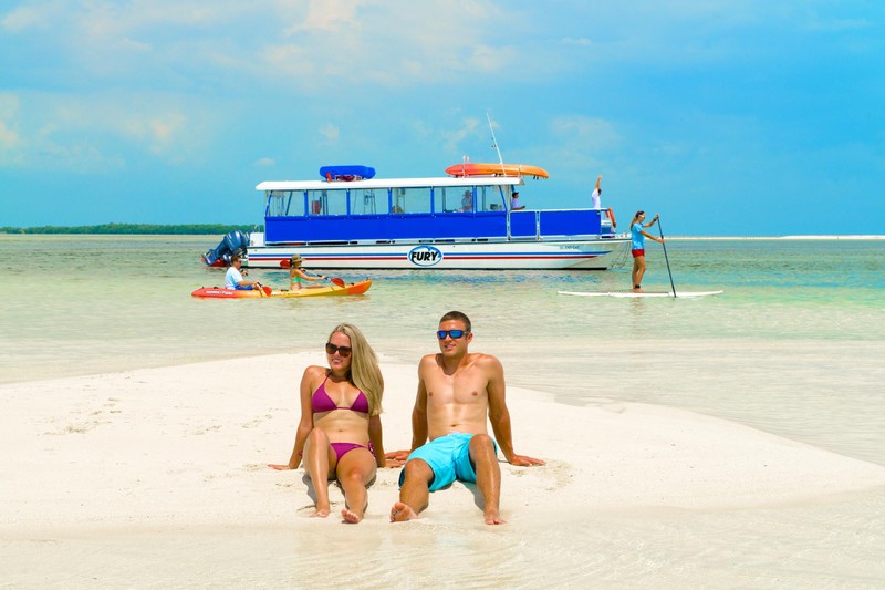 couple sitting on a sandbar