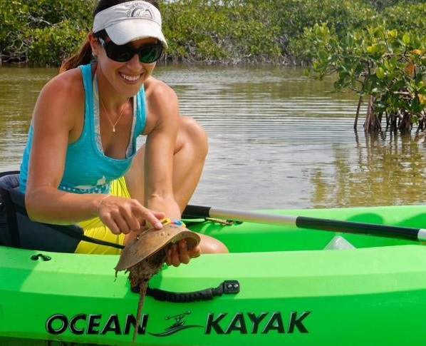 lady poking a man on a kayak