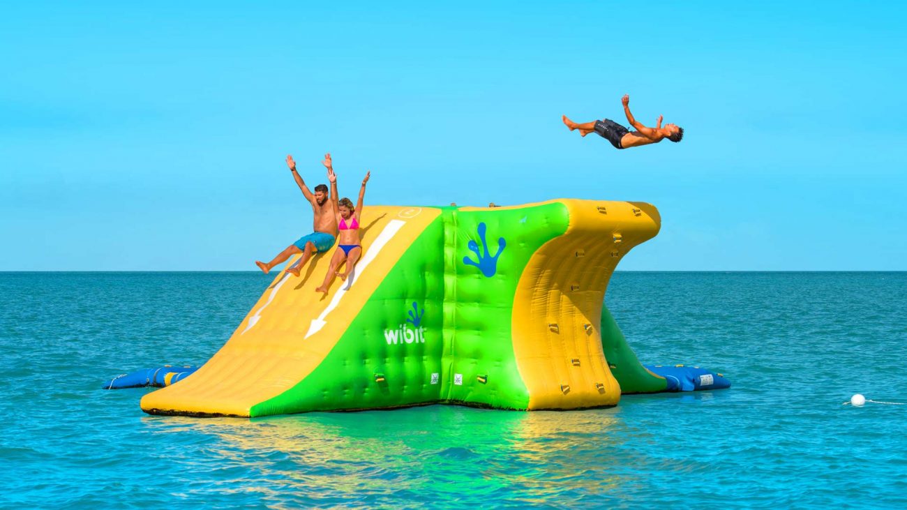 Father and Daughter sliding down into the ocean